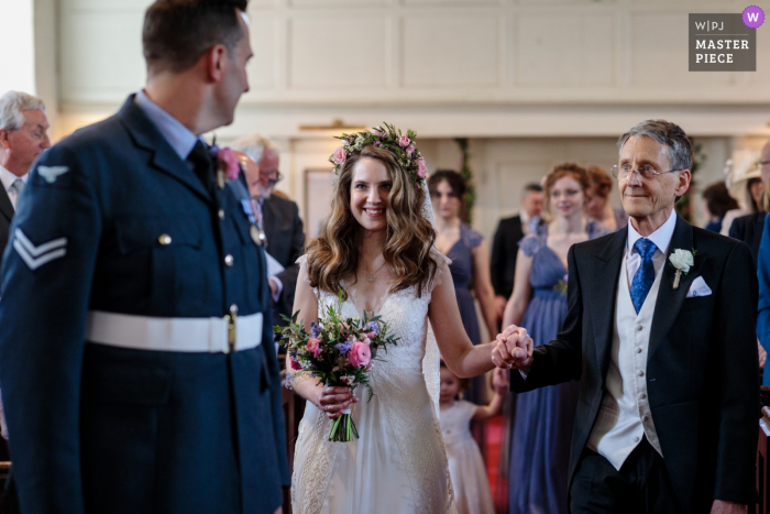 Photo by: <a href="https://www.wpja.com/contests/2019-v10/best-wedding-photographers/2543762">Catherine Hill - Canterbury Kent</a> Hayne House, Kent, UK wedding ceremony photo of the bride arriving up the aisle with her father to meet her husband to be.