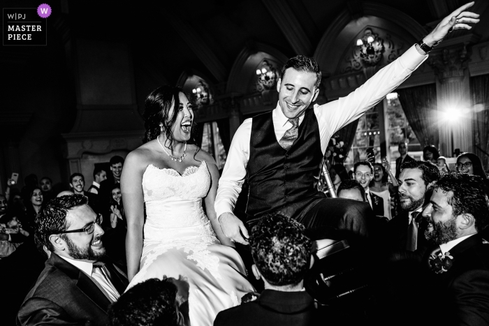 Photo by: <a href="https://www.wpja.com/contests/2019-v11/best-wedding-photographers/2544713">Wenjie Han - Long Island City New York</a> Black and white wedding photo of a bride and groom at the chair dance during their Ashford Estate wedding.