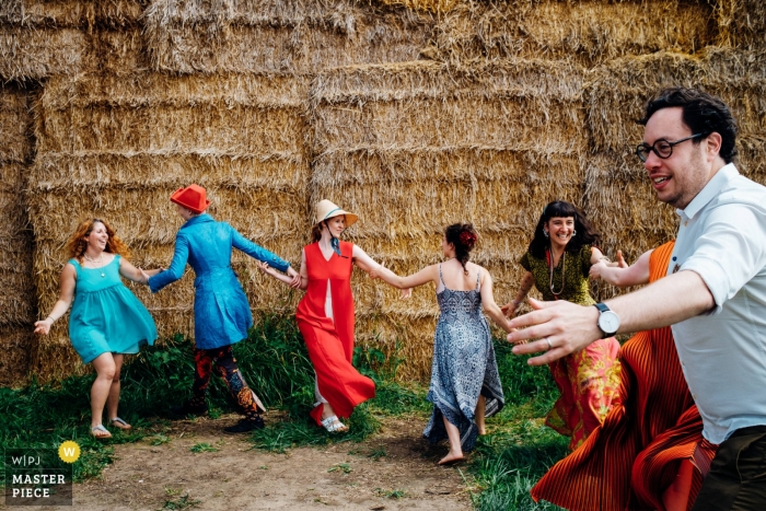 Photo by: <a href="https://www.wpja.com/contests/2019-v11/best-wedding-photographers/2544824">Marianne Chua - London London</a> London England Wedding Reportage Photos at the Outdoor Reception of Guests Dancing in a Chain Line - Marlow wedding photographer