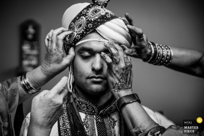 Photo by: <a href="https://www.wpja.com/contests/2019-v11/best-wedding-photographers/2544966">Kathleen Ricker - Linthicum Heights Maryland</a> Washington DC wedding photo of groom receiving help getting ready for his wedding..