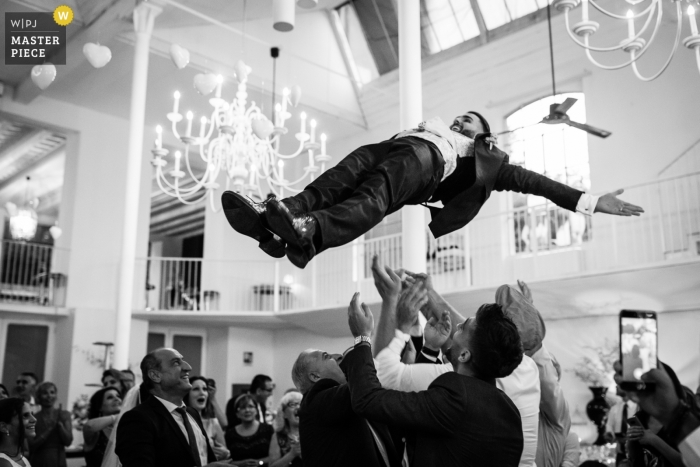 Photo by: <a href="https://www.wpja.com/contests/2019-v11/best-wedding-photographers/2545120">Alessandro Arena - Tradate Varese</a> Wedding Venue Location: La Madonnina Cantello - Photo of the groom is thrown up in the air by his friends.