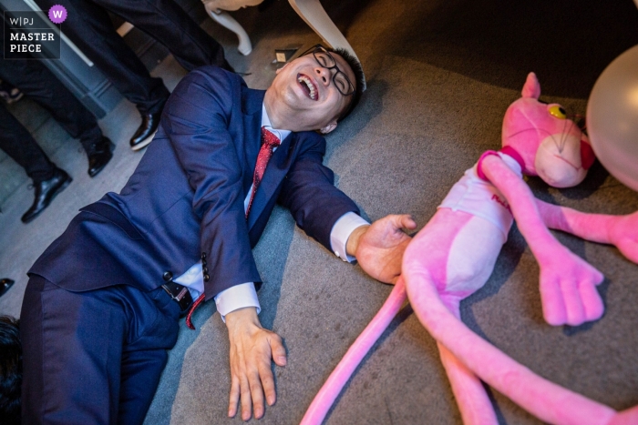 Groom and Pink Panther stuffed animal games. China Beijing wedding day photography with Groom and Pink Panther stuffed animal games.