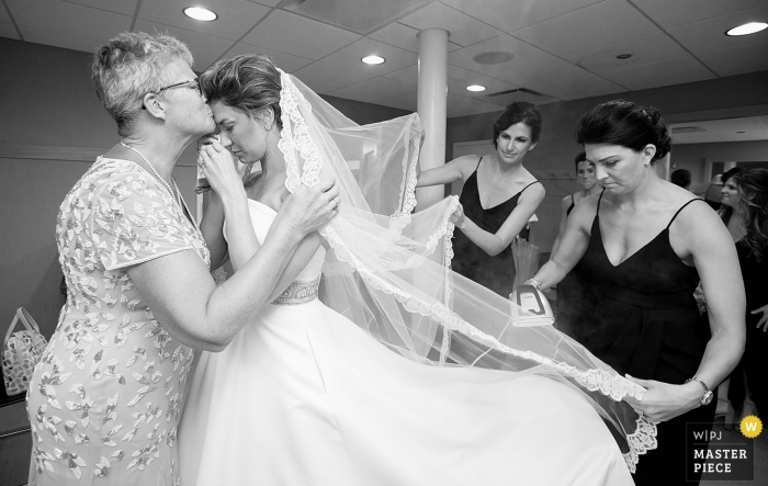 Photo by: <a href="https://www.wpja.com/contests/2019-v11/best-wedding-photographers/2545490">Anne Ryan - Chicago Illinois</a> Photograph of an emotional moment between mother and daughter before the ceremony at Old St. Patrick's Church, Chicago, Illinois