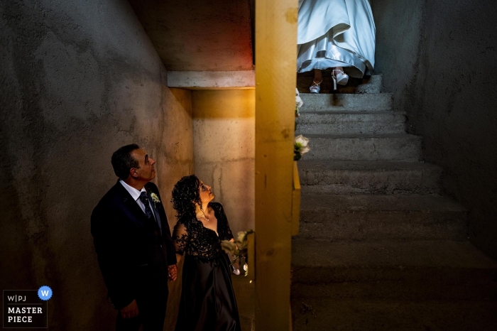Photo by: <a href="https://www.wpja.com/contests/2019-v11/best-wedding-photographers/2545850">Pasquale Minniti - Reggio Calabria</a> Bride ascends down the stairs, leaving the house to attend her Reggio Calabria wedding.