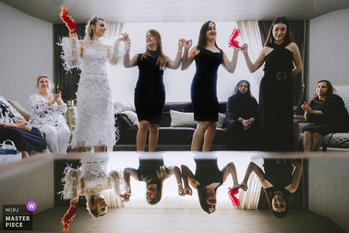 A traditional Turkish dance and the reflection on the glass table Wedding Photography at the Bride's Home /Mersin/Turkey | A traditonal Turkish dance and the reflection on the glass table