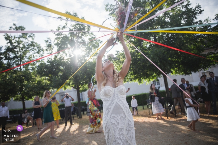 Photo by: <a href="https://www.wpja.com/contests/2019-v11/best-wedding-photographers/2546100">Simon Cassanas - Paris </a> école militaire paris photography of bride bouquet game at the wedding reception
