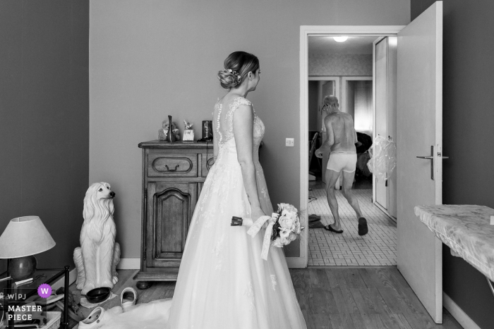Photo by: <a href="https://www.wpja.com/contests/2019-v11/best-wedding-photographers/2546125">Sylvain Bouzat - Lyon </a> Lyon, France Wedding Reportage Photographer | A bride in her room and the father walk behind the door