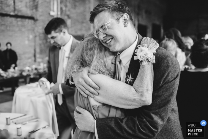 Photo by: <a href="https://www.wpja.com/contests/2019-v11/best-wedding-photographers/2546188">Dennis Crider - Loudonville Ohio</a> Reception Venue Photography in Ohio - Big emotional hugs by the family