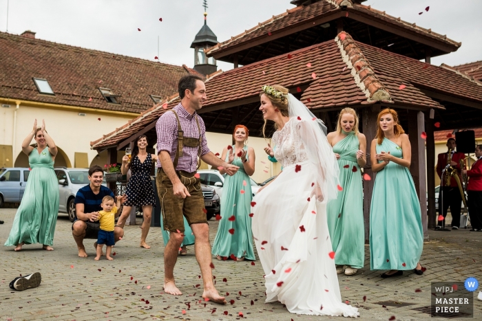 Photo by: <a href="https://www.wpja.com/contests/2019-v11/best-wedding-photographers/2546388">Matouš Bárta - Prague </a> Sudický Dvůr barefoot first dance photos outside with bride, groom and wedding guests.