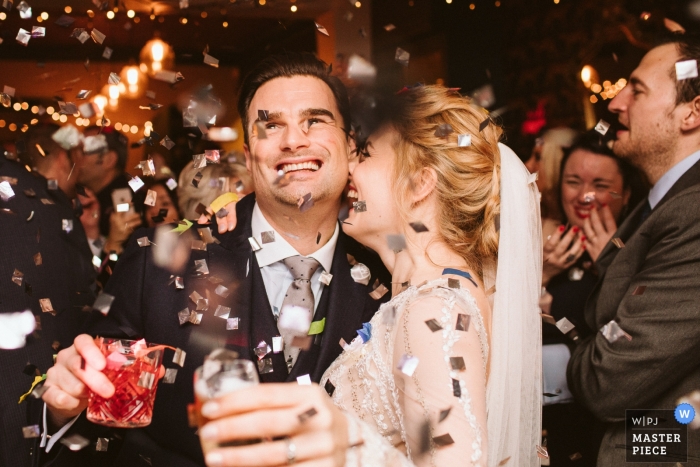 bride and groom under the Confetti Canon Chesham Wedding Photography showing the bride and groom under the Confetti Canon