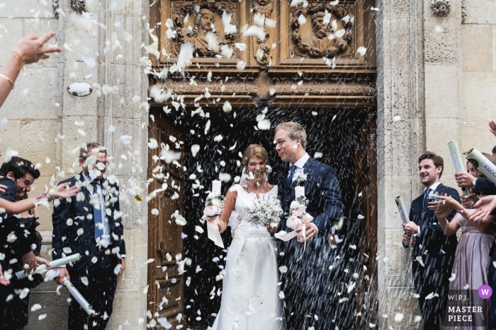 Photo by: <a href="https://www.wpja.com/contests/2019-v12/best-wedding-photographers/2548031">Franck Petit - Serignac sur Garonne </a> Photo of the bride and groom as they exit the church at their Bordeaux, France wedding ceremony.