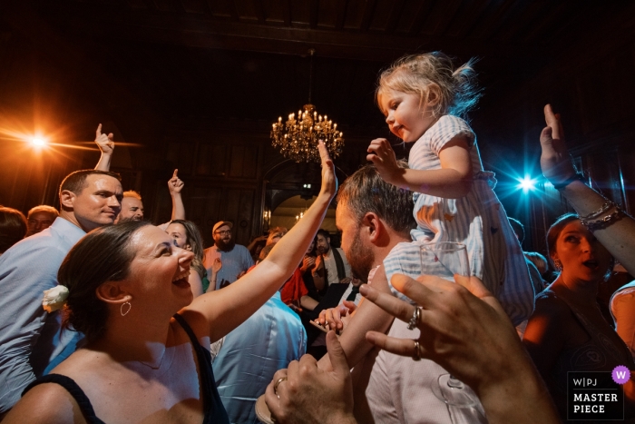 Party time with a little girl on shoulders Chateau de Maulmont, France Wedding Venue Photographer - Party time with a little girl on shoulders during reception music