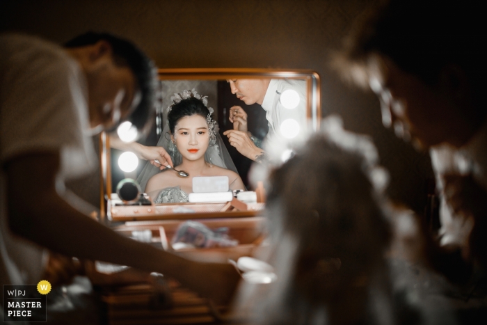 Photo by: <a href="https://www.wpja.com/contests/2019-v12/best-wedding-photographers/2548384">Leon Wong - Hangzhou </a> Wedding photography at Huzhou, Zhejiang, China Hotel | Image taken before the wedding ceremony, the two stylists were modeling the bride.