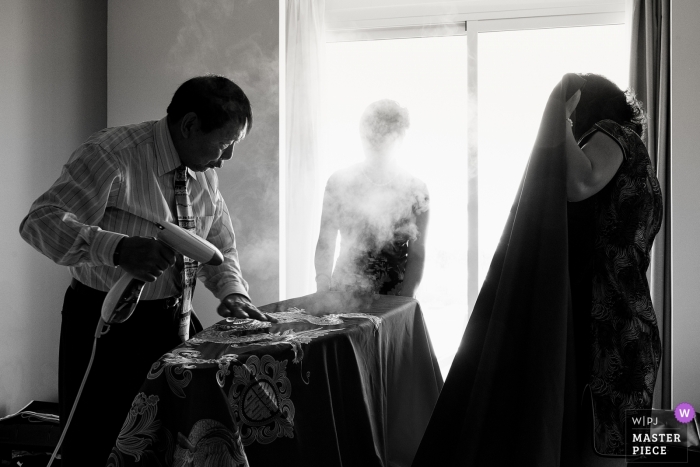 Photo by: <a href="https://www.wpja.com/contests/2019-v12/best-wedding-photographers/2548508">Xiaozhu Lin - Beijing </a> Riu Palace Costa Mujeres Hotel Wedding Day Photography of Getting ready with steam gun and dress