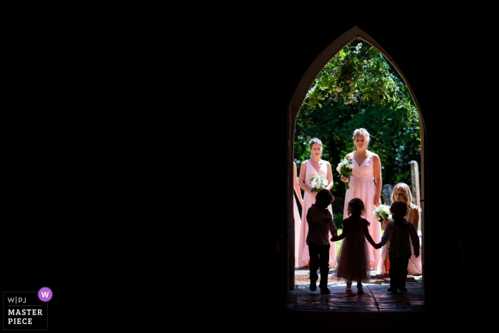 Photo by: <a href="https://www.wpja.com/contests/2019-v12/best-wedding-photographers/2548651">Tom Beynon - Cambridge Cambridgeshire</a> Park Farm, Daventry Wedding Photography | Page boys and a flower girl walk into church.