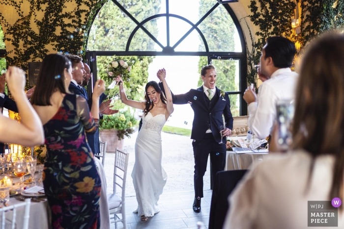 Photo by: <a href="https://www.wpja.com/contests/2019-v12/best-wedding-photographers/2548705">Alessandro Colle - Massa Massa-Carrara</a> Villa del Balbianello wedding venue photography of the moment of party entrance by the bride and groom