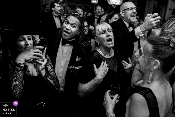 happy guests at the wedding party Rijswijk wedding photographer - black and white image of happy wedding guests at the wedding party