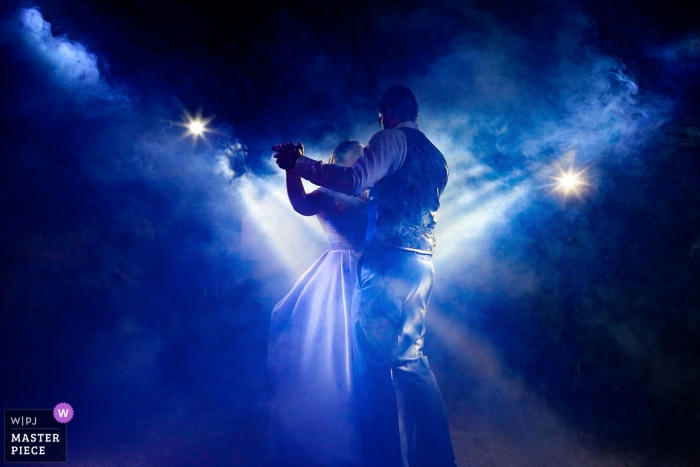 couple dancing under blue lights Aldeia das Flores - photography at the wedding reception of dancing under blue lights