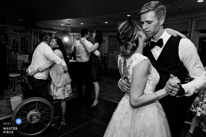 Photo by: <a href="https://www.wpja.com/contests/2019-v12/best-wedding-photographers/2548814">Kate Crabtree - Bangor Maine</a> Point Lookout wedding photography in ME - A bride dances with the groom and her guests at their Maine wedding