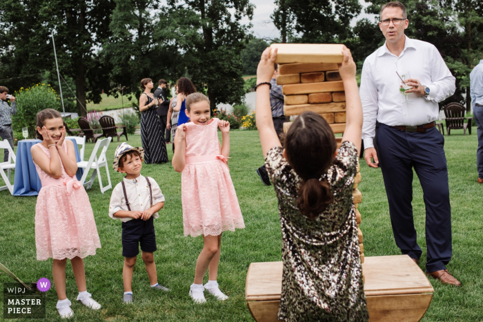 Photo by: <a href="https://www.wpja.com/contests/2019-v12/best-wedding-photographers/2548834">Meg Brock - Holland Pennsylvania</a> Chesterfield New Jersey wedding photography of Giant Jenga game at outdoor wedding reception on the grass