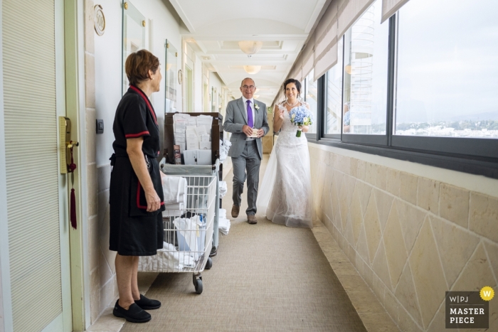 Photo by: <a href="https://www.wpja.com/contests/2019-v13/best-wedding-photographers/2549092">Jesus Merida - Malaga Malaga</a> Marbella, Hotel Melia Wedding Photography - Image contains: bride, father, housekeeper, room doors