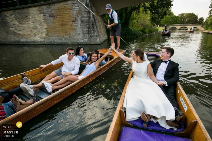 Photo by: <a href="https://www.wpja.com/contests/2019-v13/best-wedding-photographers/2549278">Aaron Storry - Kettering Northamptonshire</a> Cambridge, United Kingdom Wedding Photographer - Bride giving a high five on a punt