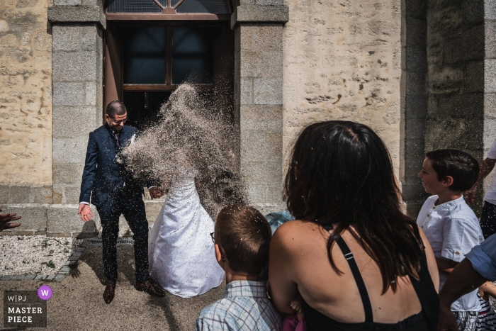 Plomeur's church, Brittany, France Wedding Ceremony Photo - The bride and the groom receive lavander at the exit of the church. 