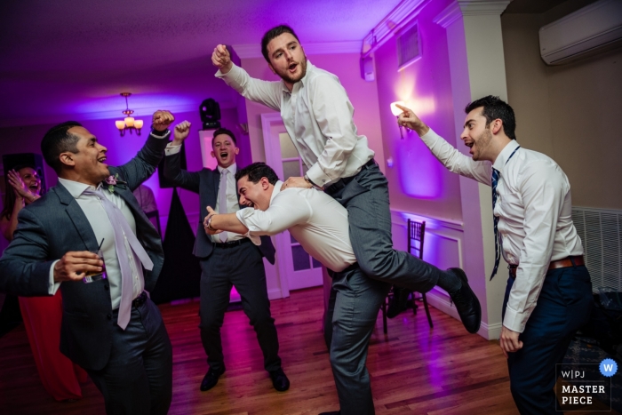Photo by: <a href="https://www.wpja.com/contests/2019-v13/best-wedding-photographers/2550231">Kathleen Ricker - Linthicum Heights Maryland</a> Warwick Country Club- Warwick RI Wedding Reception Photo - Get on it, groomsmen, dancing, purple, floor