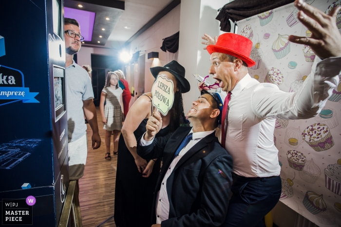 Photo: <a href="https://www.wpja.com/contests/2019-v13/best-wedding-photographers/2550372"> Piotr Maksa - Lodz Lodzkie </a> Photographie de lieu à la maison de mariage Venge, Lodz, Pologne - Le groupe d'invités au mariage s'amuse devant le photomaton.