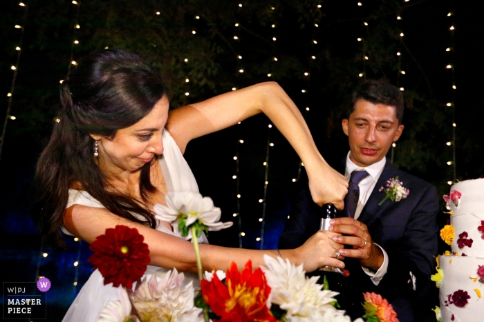 Photo by: <a href="https://www.wpja.com/contests/2019-v13/best-wedding-photographers/2550531">Danilo Coluccio - Siderno Reggio Calabria</a> Wedding Photography at Convento dell’Annunciata, Medole, Mantova Reception / Cake. Problems of open a bottle of champagne... the bride intervenes.