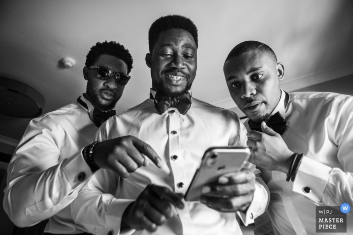 Photo by: <a href="https://www.wpja.com/contests/2019-v13/best-wedding-photographers/2551162">Obi Nwokedi - London London</a> Doubletree by Hilton, Docklands, London Wedding Photos of Groomsmen checking Mobile Phone