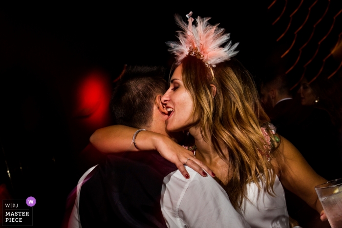 Photo by: <a href="https://www.wpja.com/contests/2019-v13/best-wedding-photographers/2551254">Miguel Onieva - Madrid Madrid</a> Spain wedding party reception photography of the bride biting groom ear at party