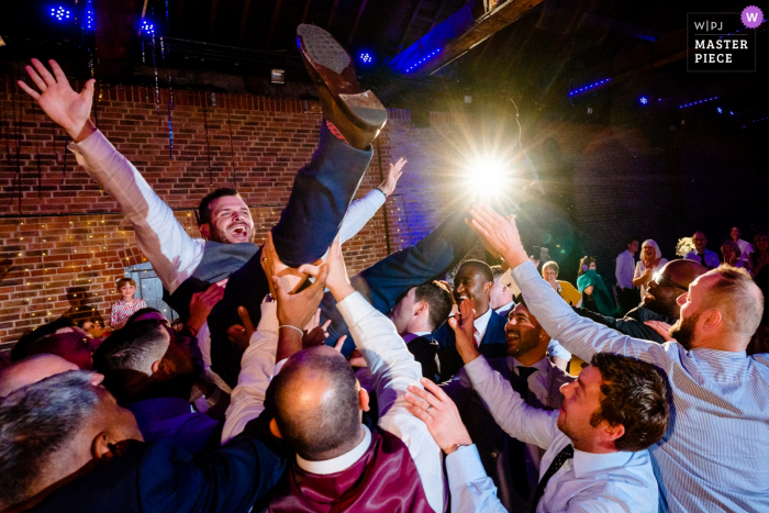 Photo by: <a href="https://www.wpja.com/contests/2019-v13/best-wedding-photographers/2551406">Paul Rogers - Hitchin Hertfordshire</a> The Brewery, London, UK Wedding Venue Photos | Groom during Greek dancing at the reception.