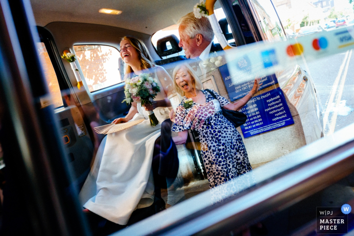 Chelsea Old Town Hall, London, UK Wedding Photography | Bride and Father are greeted by her Mother at Chelsea Old Town Hall 