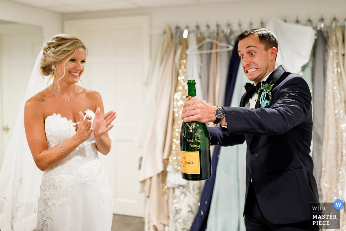 The groom opens bottle of champagne Wychmere Beach Club Wedding Venue Photography | The groom opens bottle of champagne