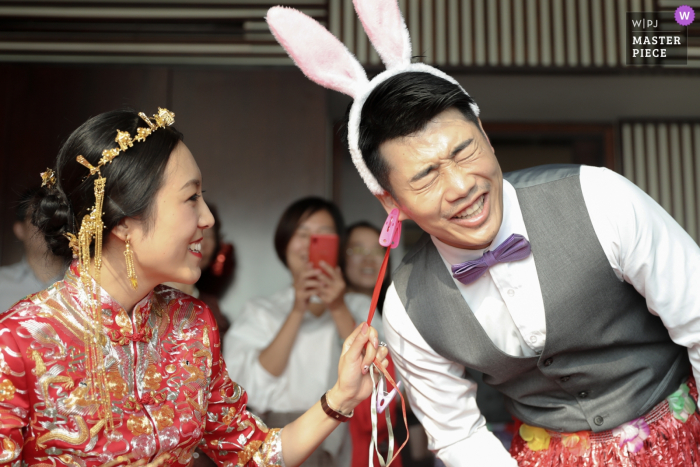 Photo by: <a href="https://www.wpja.com/contests/2019-v14/best-wedding-photographers/2552299">Xiaoye Sun - Beijing </a> Beijing China bride and groom with bunny ears - Humor, funny, wedding, photography