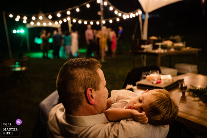 Photo by: <a href="https://www.wpja.com/contests/2019-v14/best-wedding-photographers/2552312">David Clumpner - Missoula Montana</a> Stryker, Montana Wedding Photography - asleep kid during reception