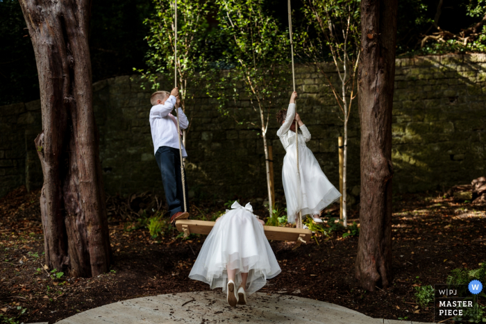 Photo by: <a href="https://www.wpja.com/contests/2019-v14/best-wedding-photographers/2552369">Catherine Hill - Canterbury Kent</a> The Orangery, Maidstone, Kent UK Wedding Reportage Photography - The paige boy and flower girls enjoying swining