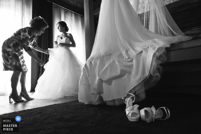 Photo by: <a href="https://www.wpja.com/contests/2019-v14/best-wedding-photographers/2552622">Franck Boutonnet - Lyon </a> Lyon Hotel Wedding Photography - The mam of the bride is helping her with the last touch to get ready