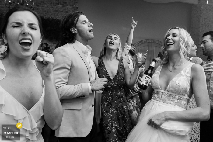 Photo by: <a href="https://www.wpja.com/contests/2019-v14/best-wedding-photographers/2552706">Cindy Brown - Atlanta Georgia</a> Wrightsville Manor, Wrightville, SC Wedding Photographer - Singing while dancing at the reception party