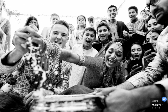 Photo by: <a href="https://www.wpja.com/contests/2019-v14/best-wedding-photographers/2552882">Emil Boczek - Wolverhampton West Midlands</a> Wedding Photographer for Froyle Park wedding venue, UK - Hindu wedding game of ring fishing
