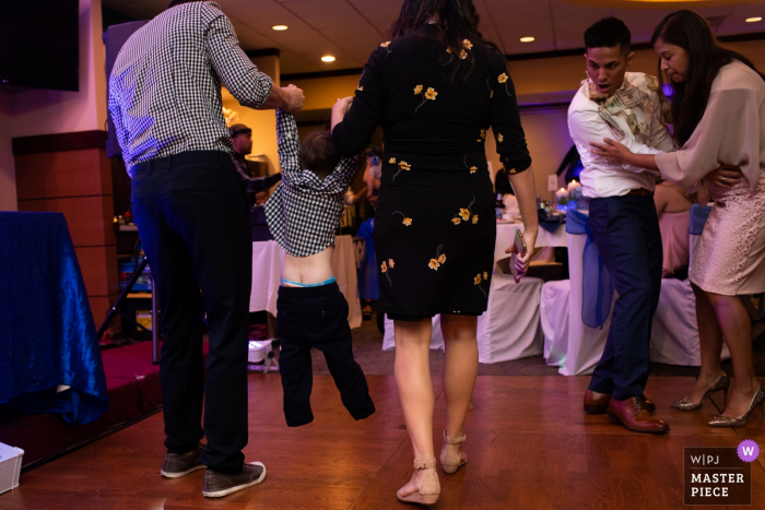 Photo by: <a href="https://www.wpja.com/contests/2019-v14/best-wedding-photographers/2553011">Siliang Wang - San Jose California</a> New Port Restaurant in Cupertino | Wedding Photographer | The child is pulled out of the dance floor by the parents