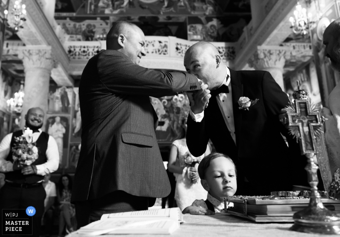 Photo by: <a href="https://www.wpja.com/contests/2019-v14/best-wedding-photographers/2553432">Robert David - Bucharest </a> Romania Ceremony - Wedding Photography of hand kiss and expressions