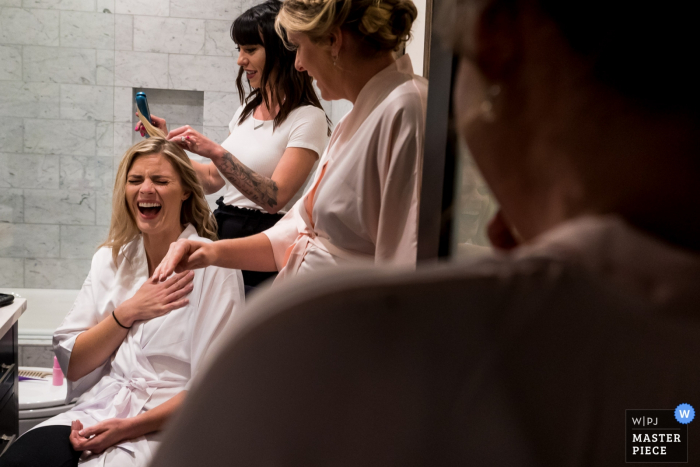 Colorado Hotel Photography on Wedding Day - Bride laughing with bridesmaids during bridal prep 