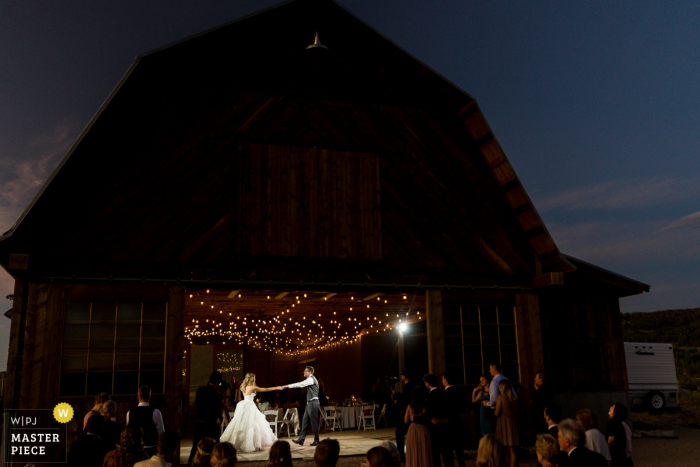 Photo by: <a href="https://www.wpja.com/contests/2019-v14/best-wedding-photographers/2554328">Brenda Bergreen - Evergreen Colorado</a> Colorado Reception Venue Photography - Bride and groom share first dance at sunset - lit barn photos at night.
