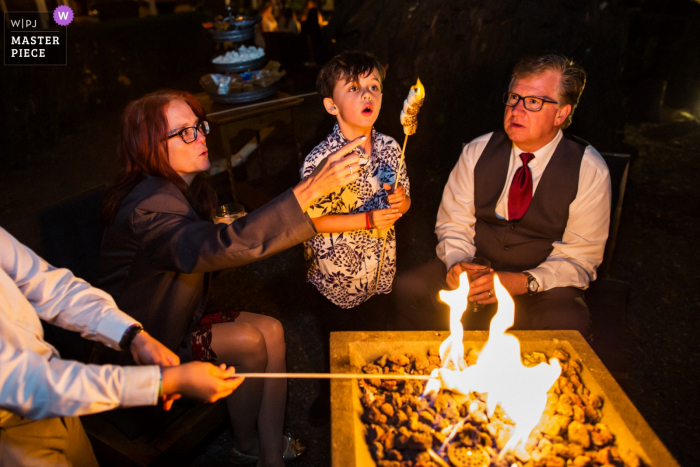 Photo by: <a href="https://www.wpja.com/contests/2019-v14/best-wedding-photographers/2554373">Chris Shum - Sunnyvale California</a> Grandma, the marshmallow is on fire! - Wedding reception photography at night with an open pit fire. - Deer Park Villa, Fairfax Wedding Venue Photos