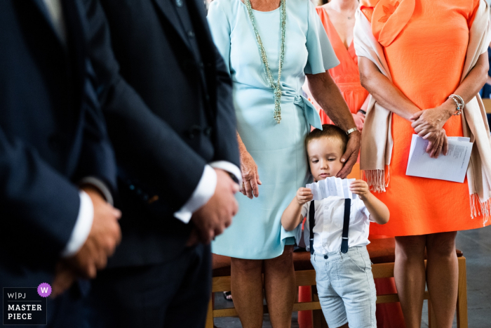 Photo by: <a href="https://www.wpja.com/contests/2019-v15/best-wedding-photographers/2554791">Joshua Dhondt - Antwerpen</a> Chateau de la Rocq, Feluy wedding photography at the church with boy reading