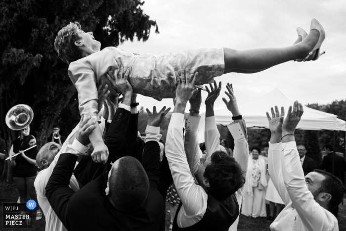 wedding photographer for Jardins d'Eyrignac | Boys are throwing the mother in law in the air