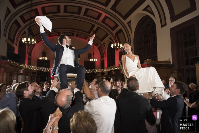 Photo by: <a href="https://www.wpja.com/contests/2019-v15/best-wedding-photographers/2555210">Adena Stevens - Hoboken New Jersey</a> Celebrate Snug Harbor - wedding photos of the bride and groom during hora