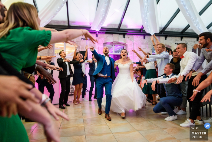 Photo by: <a href="https://www.wpja.com/contests/2019-v15/best-wedding-photographers/2555311">Julien Roman - Paris </a> Île-de-France Reception venue photographer — Bride and groom entering the reception venue